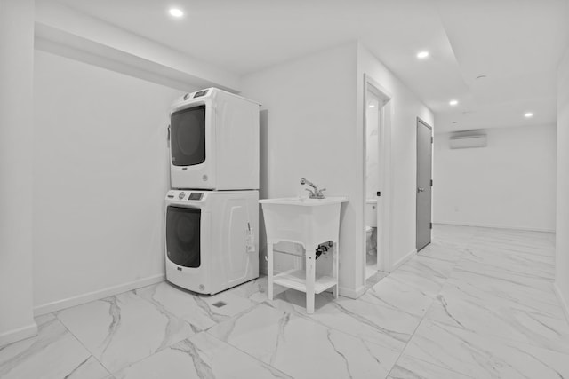 clothes washing area with stacked washer and dryer and a wall unit AC