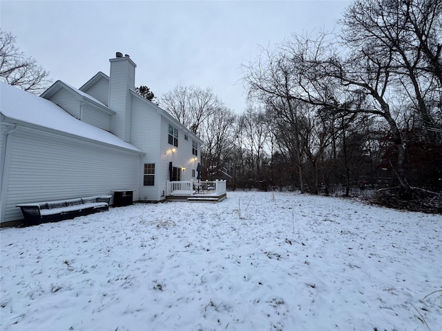 yard covered in snow featuring a deck