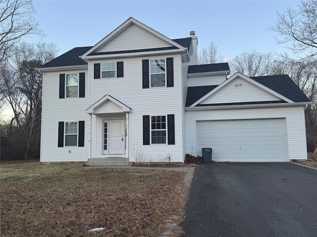 view of front of house with a garage and a front yard