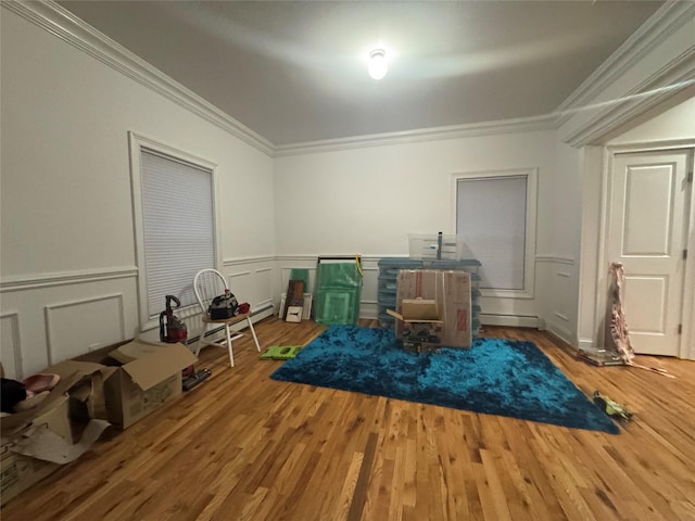 game room with crown molding, wood-type flooring, and baseboard heating