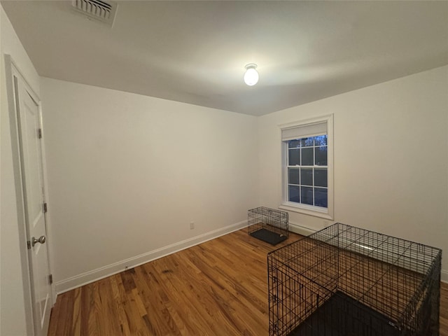 empty room with hardwood / wood-style floors