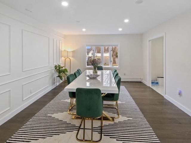 dining space featuring dark wood-type flooring and a baseboard radiator