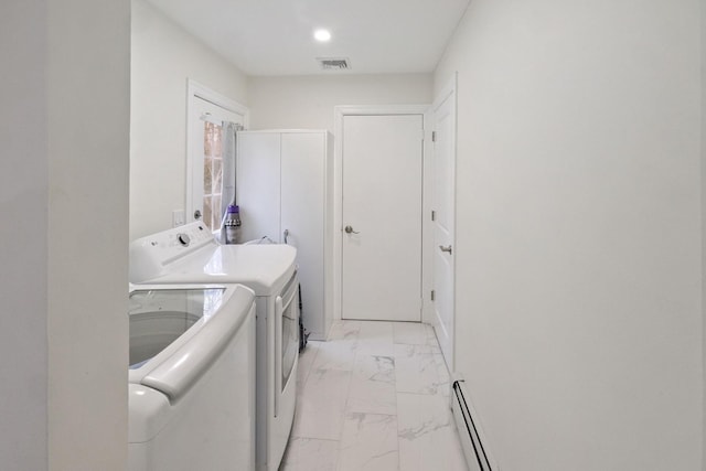 laundry room with a baseboard radiator and separate washer and dryer