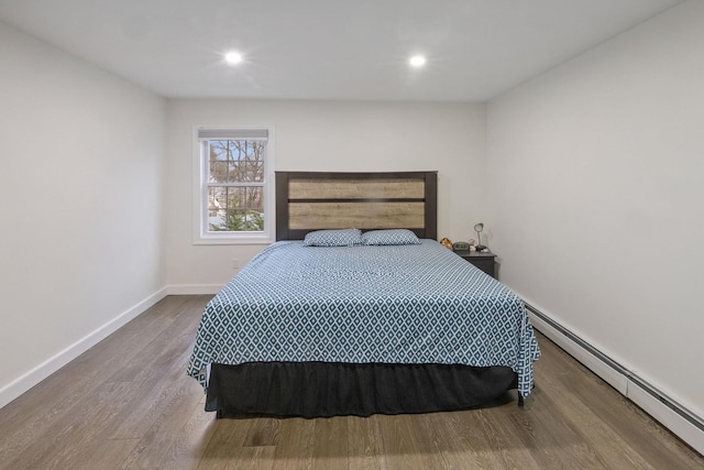 bedroom featuring a baseboard radiator and wood-type flooring