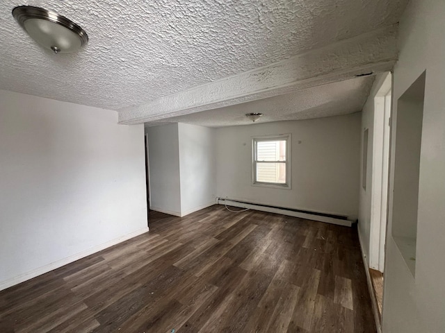 unfurnished room featuring dark wood-type flooring, a textured ceiling, and a baseboard heating unit