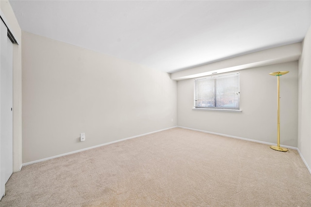 spare room featuring light colored carpet