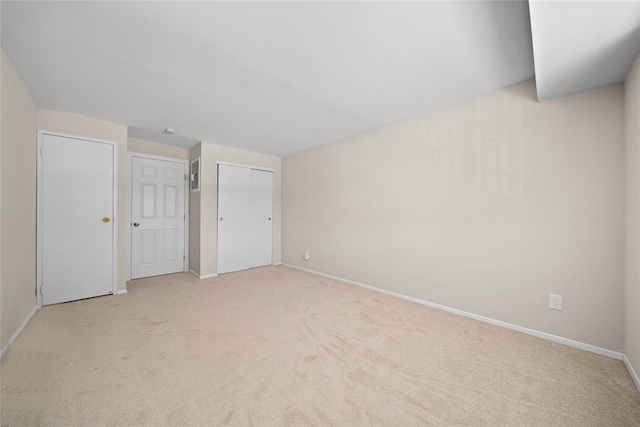 unfurnished bedroom with light colored carpet