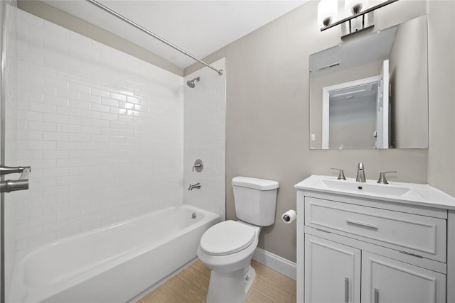 full bathroom featuring tiled shower / bath combo, vanity, and toilet