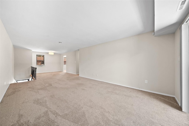 unfurnished living room with light colored carpet and baseboard heating