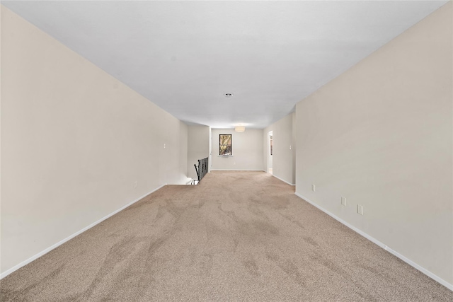 spare room featuring light colored carpet