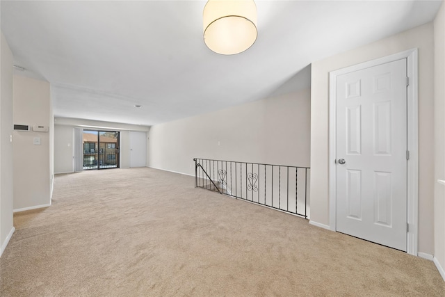 unfurnished room with light colored carpet