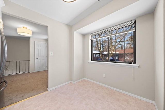 spare room with light colored carpet