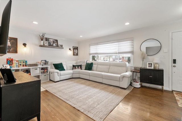 living room featuring wood-type flooring and ornamental molding