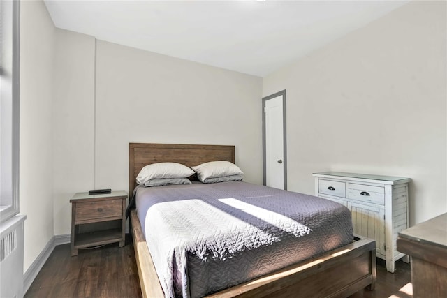 bedroom featuring dark hardwood / wood-style flooring and radiator