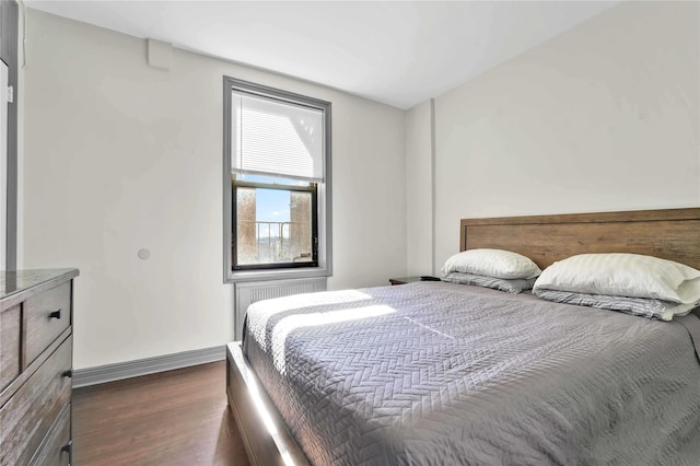 bedroom featuring dark wood-type flooring and radiator