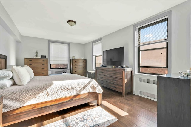 bedroom featuring radiator and dark hardwood / wood-style flooring