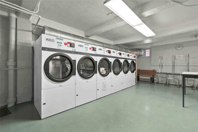 laundry room with separate washer and dryer and a textured ceiling