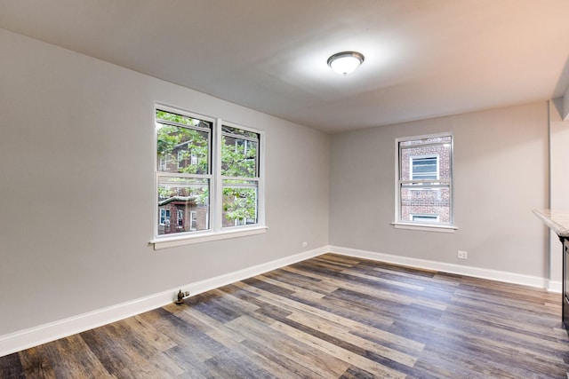 spare room with dark hardwood / wood-style floors