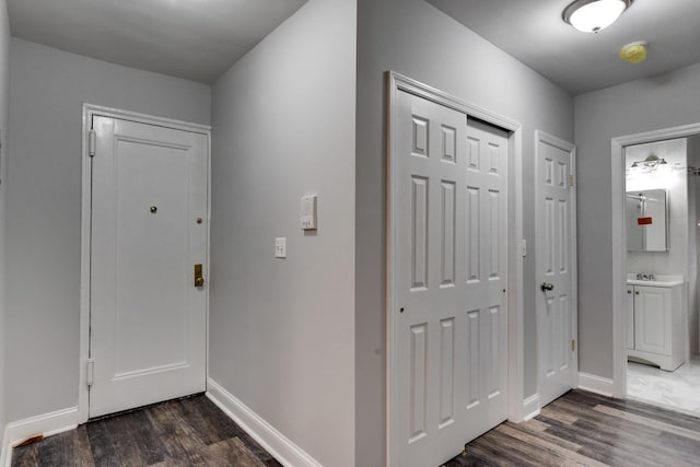 entryway with dark hardwood / wood-style flooring