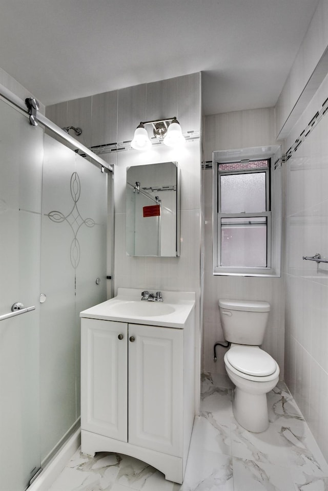 bathroom with vanity, toilet, tile walls, and walk in shower