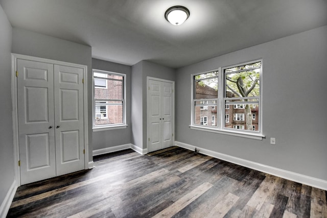 unfurnished bedroom with dark hardwood / wood-style floors