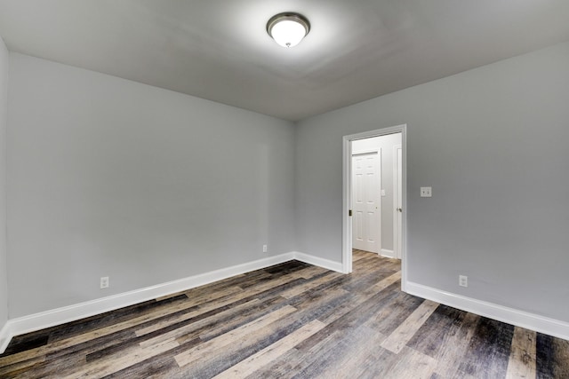 unfurnished room with dark hardwood / wood-style floors