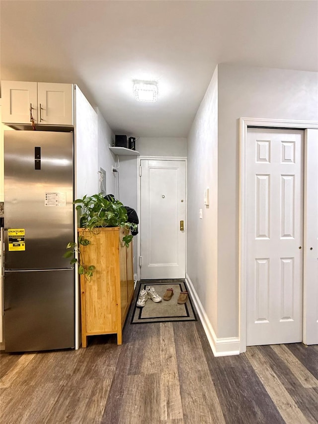 corridor with dark hardwood / wood-style flooring