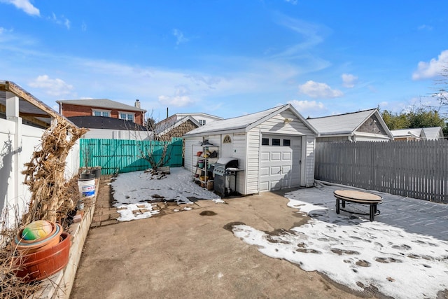 view of yard with a garage, an outdoor structure, and a fire pit