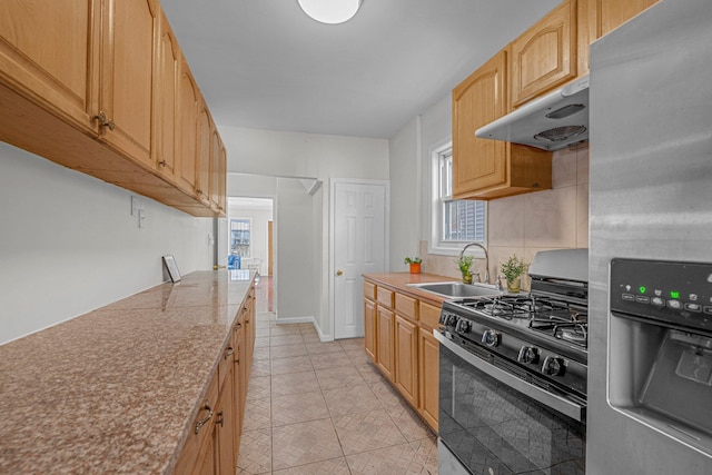 kitchen with stainless steel fridge with ice dispenser, sink, gas stove, and a healthy amount of sunlight