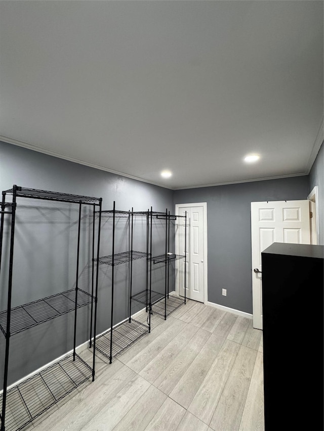 unfurnished room featuring crown molding and light hardwood / wood-style flooring