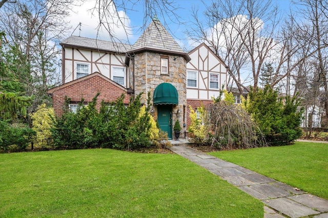 english style home with a front yard