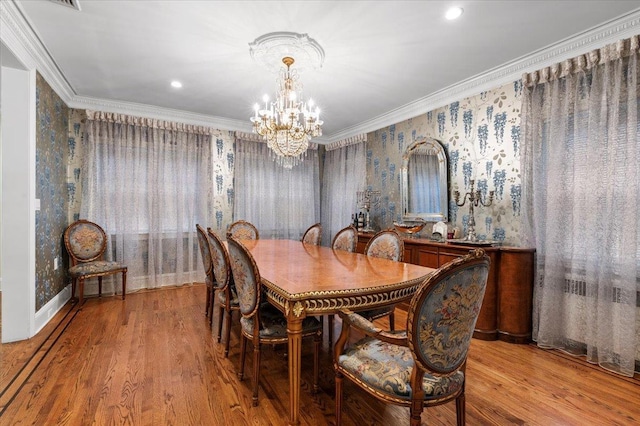 dining room featuring crown molding, a chandelier, and light wood-type flooring