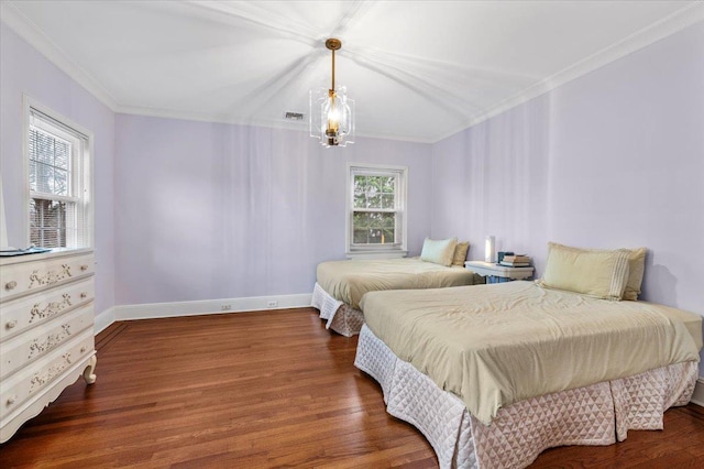 bedroom featuring ornamental molding, a chandelier, and dark hardwood / wood-style flooring