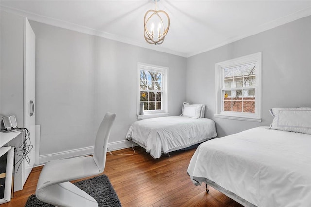 bedroom with multiple windows, ornamental molding, hardwood / wood-style flooring, and a notable chandelier