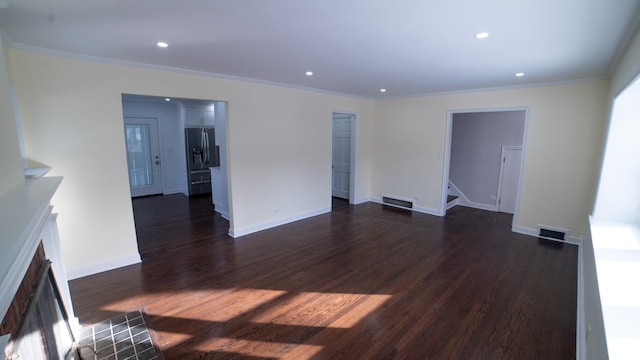 unfurnished living room featuring crown molding and dark hardwood / wood-style floors