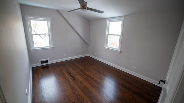 bonus room featuring ceiling fan and dark hardwood / wood-style flooring