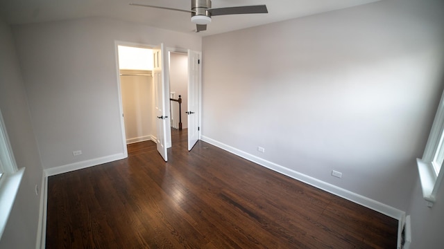 unfurnished bedroom with ceiling fan, dark hardwood / wood-style flooring, and a closet