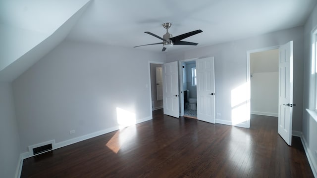 unfurnished bedroom with dark wood-type flooring, ceiling fan, and ensuite bath