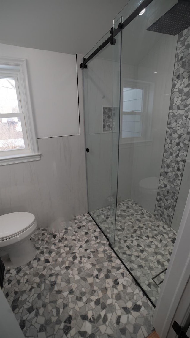 bathroom featuring toilet and walk in shower