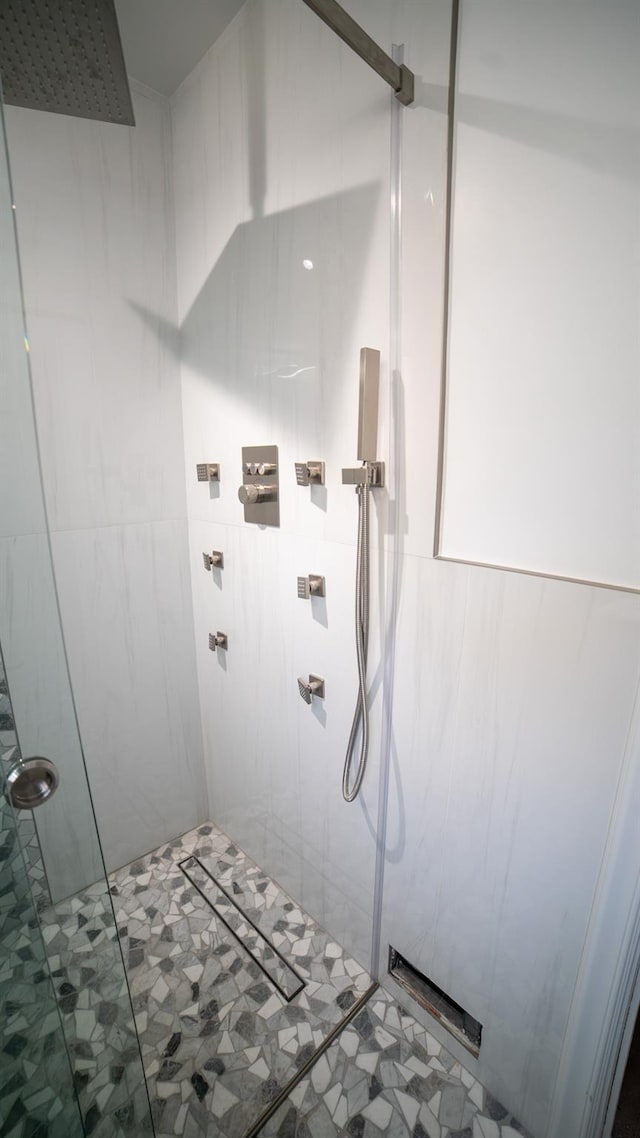 bathroom featuring a shower with door