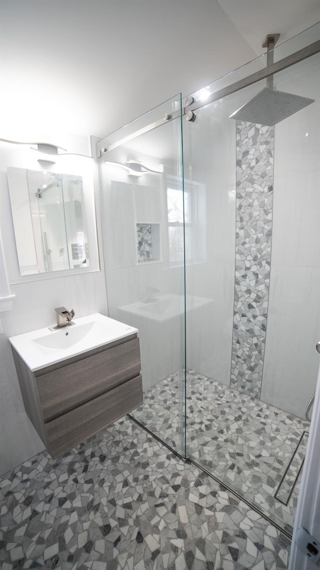 bathroom with vanity and a tile shower