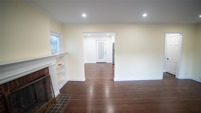 unfurnished living room featuring crown molding, dark hardwood / wood-style flooring, and a tile fireplace