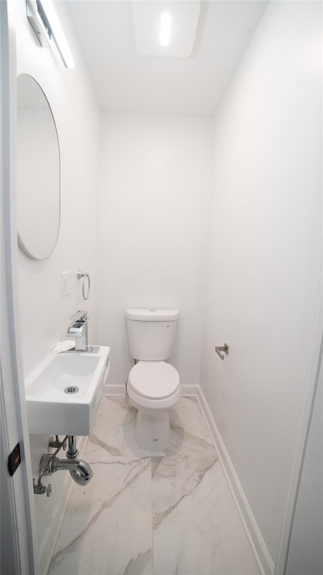 bathroom featuring sink and toilet