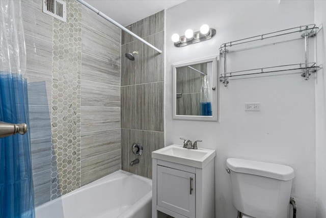 bathroom featuring toilet, visible vents, shower / tub combo with curtain, and vanity