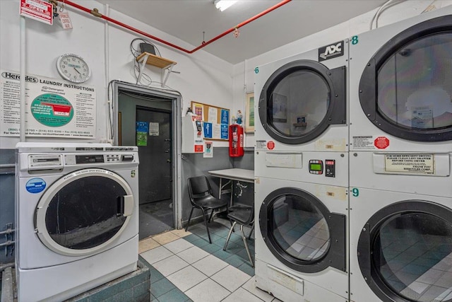 common laundry area with stacked washer and dryer, washer and dryer, and tile patterned floors