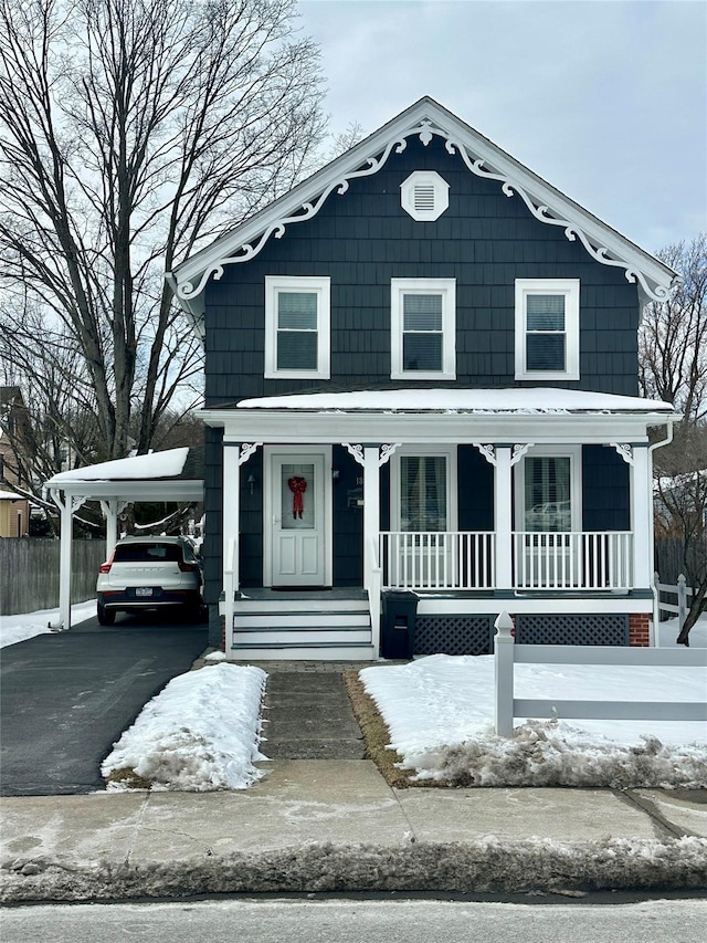 view of front of house featuring a carport and covered porch