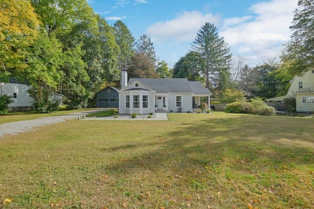 view of front of property featuring a garage and a front lawn