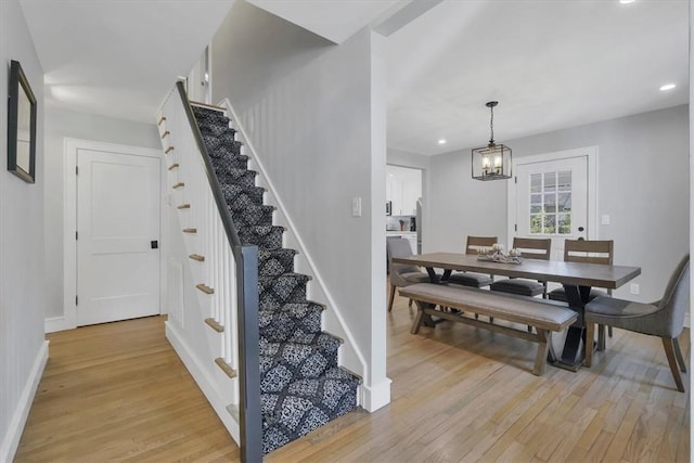 dining room with a notable chandelier and light hardwood / wood-style flooring