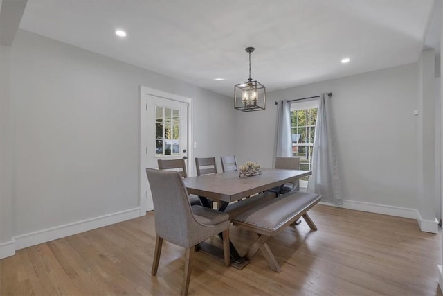 dining room featuring a notable chandelier and light wood-type flooring