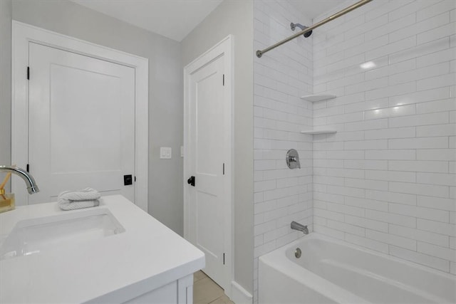 bathroom with vanity and tiled shower / bath combo